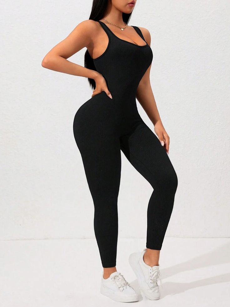 Person wearing a black jumpsuit on a white background